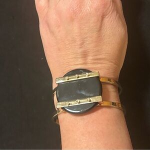 Very trendy bangle bracelet in gold and black. Statement/ conversation piece